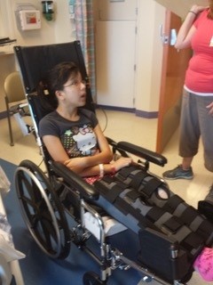 Megan in wheelchair after leg surgery