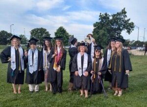 Megan with other graduates in robes.
