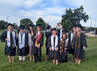 Megan with other graduates in robes.