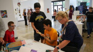 Irvin enjoying an activity at the Envision Arts Gallery as part of Camp Woodchuck.